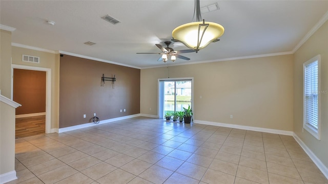 tiled empty room featuring ceiling fan and crown molding