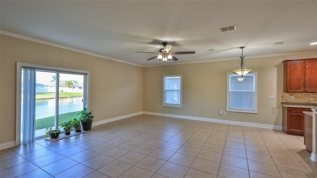 interior space with light tile patterned flooring, a healthy amount of sunlight, and decorative light fixtures