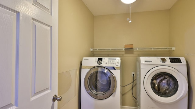 clothes washing area with separate washer and dryer