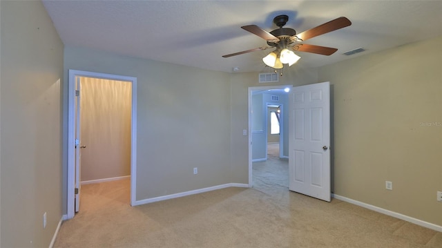 carpeted empty room featuring ceiling fan