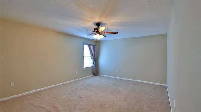 unfurnished room with a textured ceiling, light colored carpet, and ceiling fan