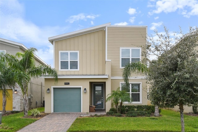 view of front of house featuring a front lawn and a garage