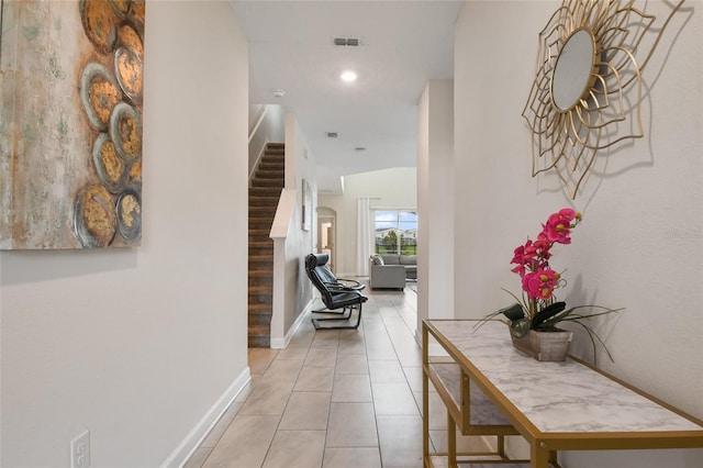 hall featuring light tile patterned flooring