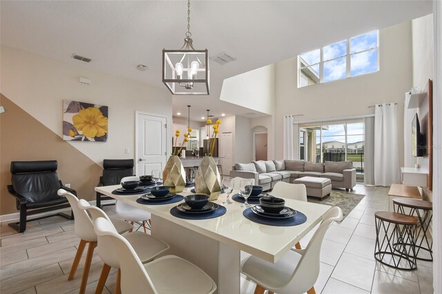 8942 Cabot Cliffs Dr, Davenport, FL 33896 - dining space with a chandelier and a high ceiling
