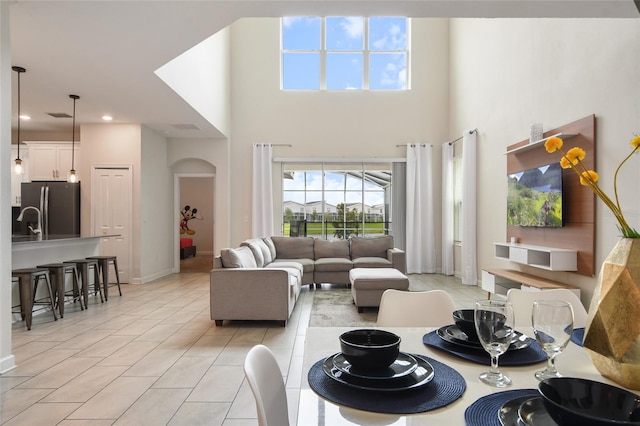 tiled living room with a towering ceiling