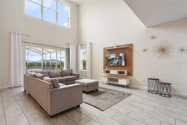 living room featuring plenty of natural light and a high ceiling