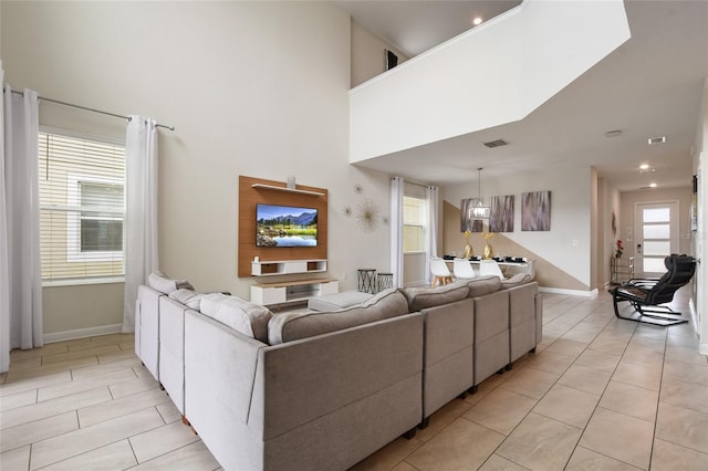 8942 Cabot Cliffs Dr, Davenport, FL 33896 - living room with light tile patterned floors, a towering ceiling, and recessed lighting