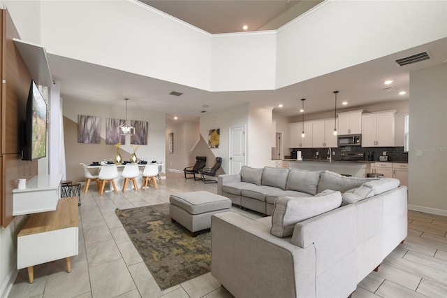 8942 Cabot Cliffs Dr, Davenport, FL 33896 - living room featuring recessed lighting, a towering ceiling, and light tile patterned floors