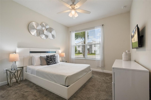 bedroom with ceiling fan and dark carpet