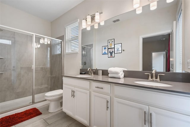 8942 Cabot Cliffs Dr, Davenport, FL 33896 - bathroom with double vanity, a shower stall, and tile patterned flooring