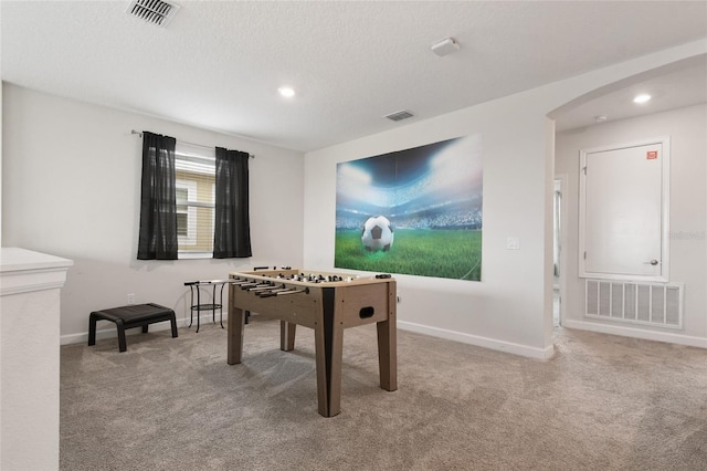 8942 Cabot Cliffs Dr, Davenport, FL 33896 - recreation room featuring arched walkways, carpet floors, recessed lighting, and a textured ceiling