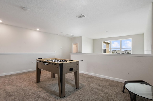 playroom featuring carpet flooring and a textured ceiling