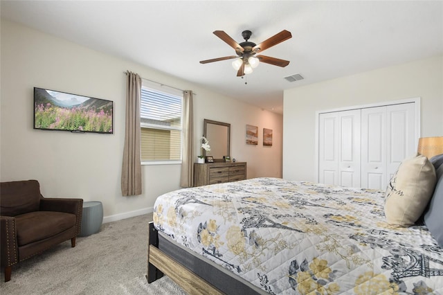 bedroom featuring ceiling fan, light carpet, and a closet