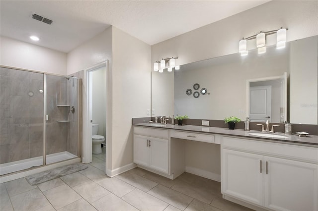 bathroom featuring tile patterned floors, walk in shower, vanity, a textured ceiling, and toilet