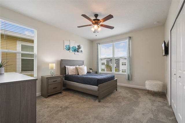 bedroom featuring light carpet, a closet, and ceiling fan