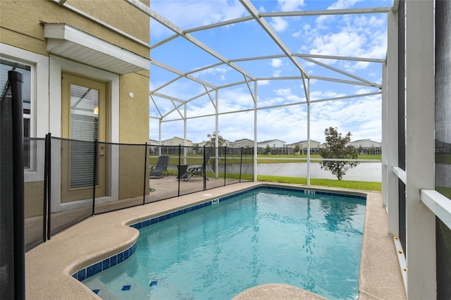 view of pool featuring a lanai, a patio, and a water view