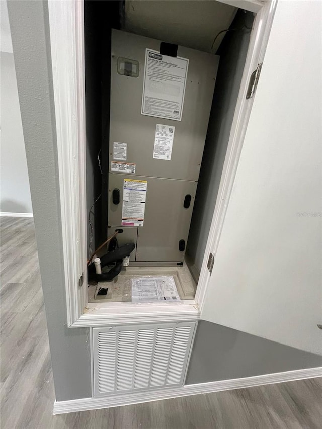 utility room featuring heating unit