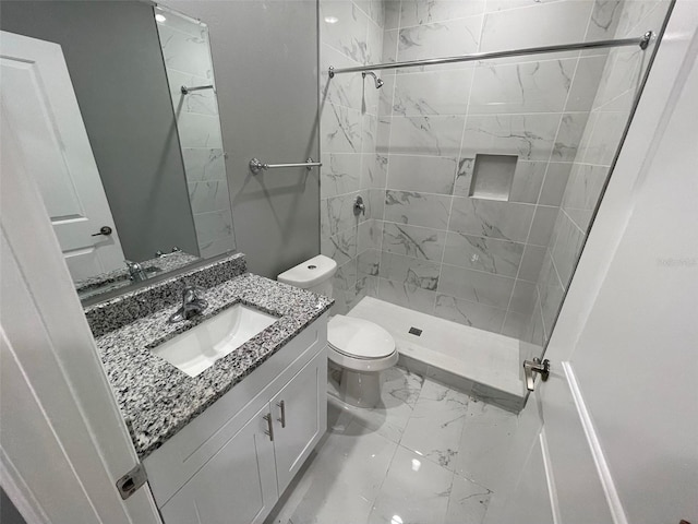 bathroom featuring tiled shower, vanity, and toilet