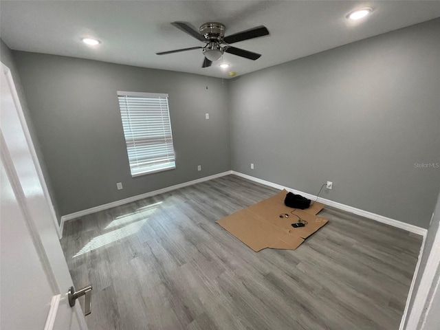 spare room with ceiling fan and hardwood / wood-style flooring