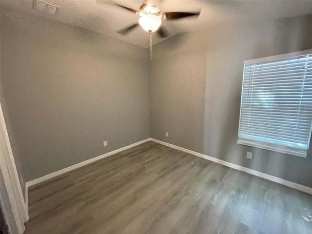 empty room featuring hardwood / wood-style flooring and ceiling fan