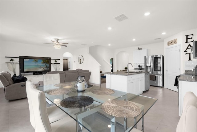 dining space featuring recessed lighting, visible vents, arched walkways, ceiling fan, and light tile patterned flooring