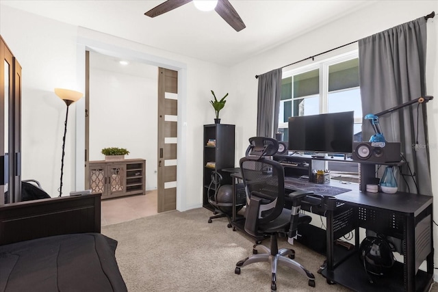 office featuring light carpet, ceiling fan, and light tile patterned floors