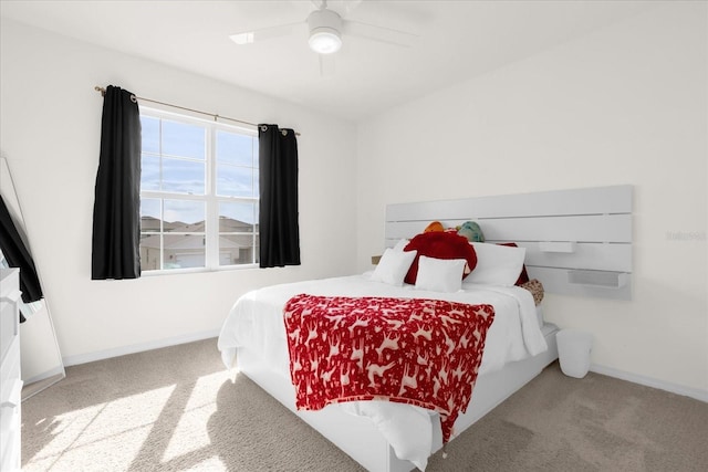 carpeted bedroom featuring a ceiling fan and baseboards