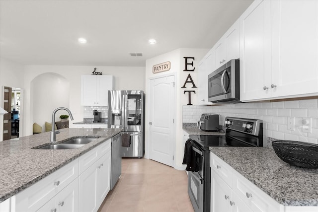 kitchen featuring white cabinets, stainless steel appliances, and a sink