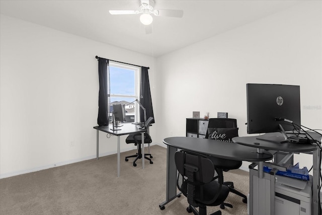 office featuring light carpet, ceiling fan, and baseboards