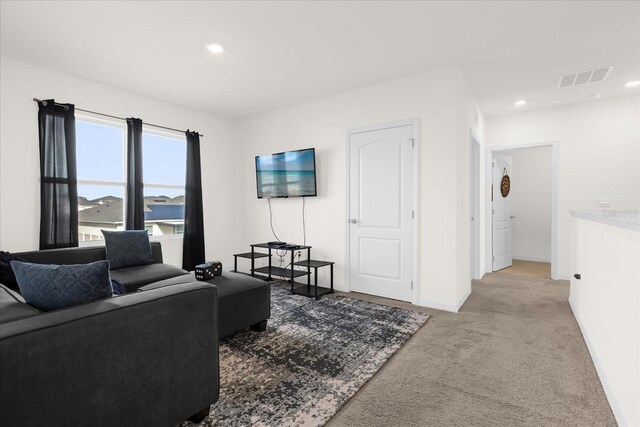 living room featuring light carpet, baseboards, visible vents, and recessed lighting