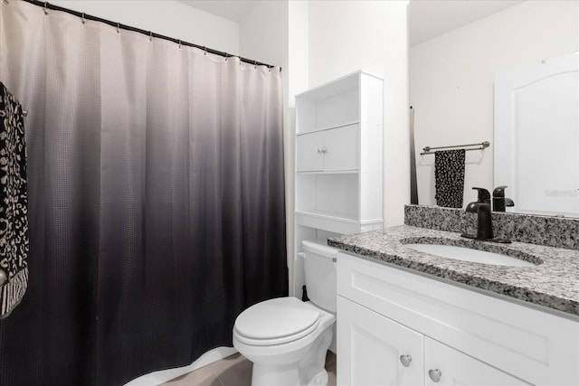 bathroom featuring toilet and vanity