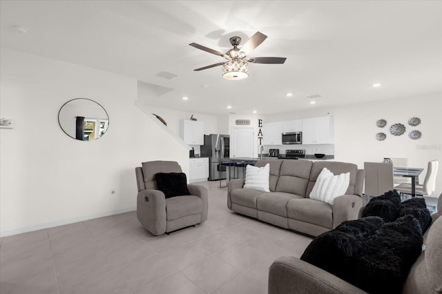 living room featuring light tile patterned floors, recessed lighting, visible vents, baseboards, and a ceiling fan