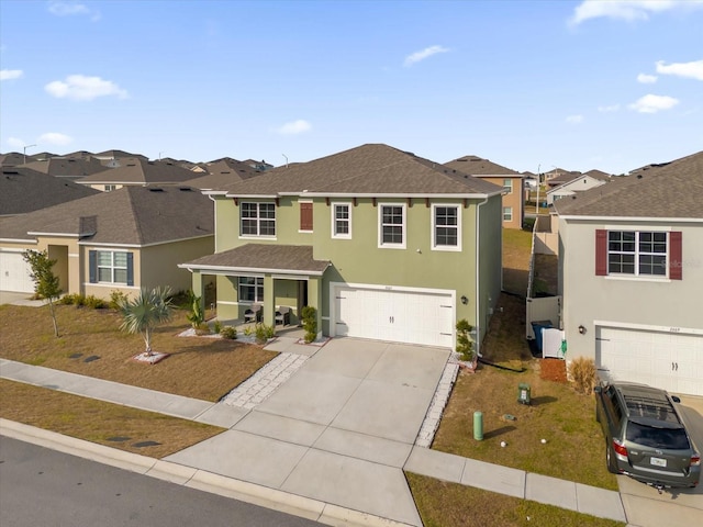 traditional home with driveway, a front yard, a residential view, and stucco siding