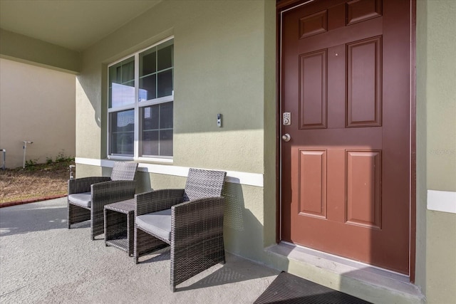 view of exterior entry featuring stucco siding