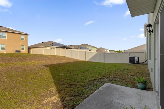 view of yard featuring a fenced backyard and central AC