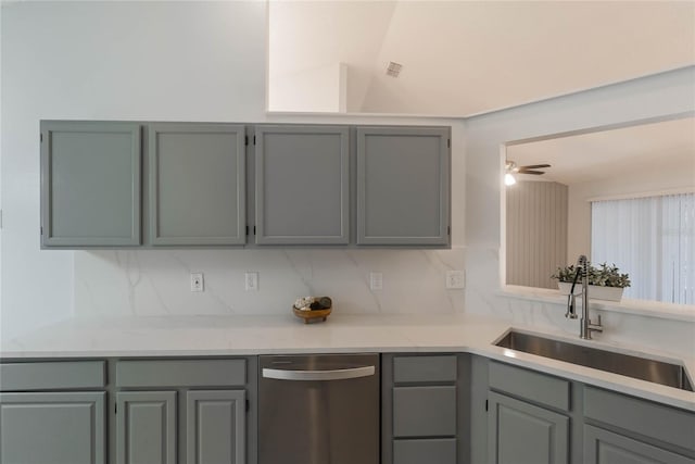 kitchen with tasteful backsplash, ceiling fan, gray cabinetry, and sink