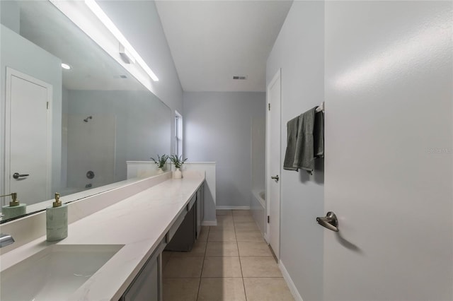 bathroom with tile patterned floors, vanity, and a bathtub