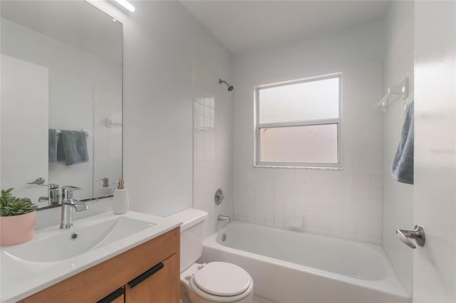 full bathroom with tiled shower / bath, vanity, and toilet