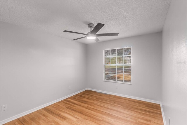 empty room featuring a textured ceiling, light hardwood / wood-style flooring, and ceiling fan