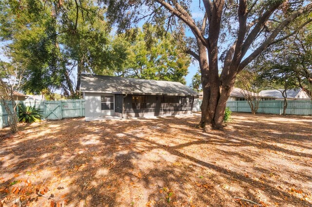 back of property with a sunroom