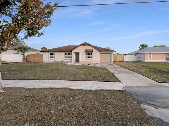 single story home with a garage and a front lawn