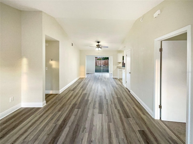 hall with dark wood-type flooring and lofted ceiling