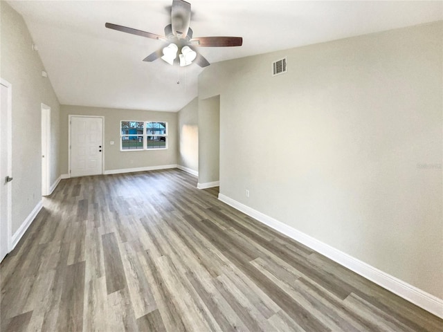 spare room featuring lofted ceiling, ceiling fan, and wood-type flooring