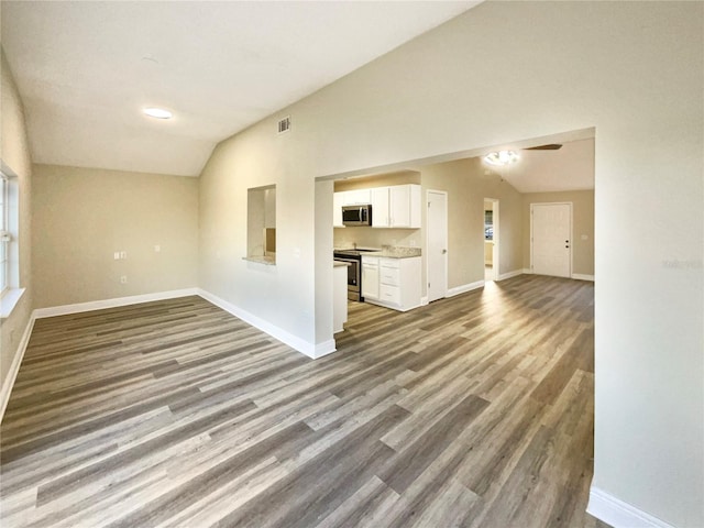 unfurnished living room with light wood-type flooring, vaulted ceiling, and ceiling fan