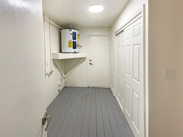 washroom featuring water heater and wood-type flooring