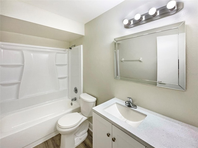 full bathroom with shower / tub combination, vanity, hardwood / wood-style flooring, and toilet