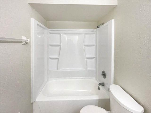 bathroom featuring shower / bathtub combination and toilet