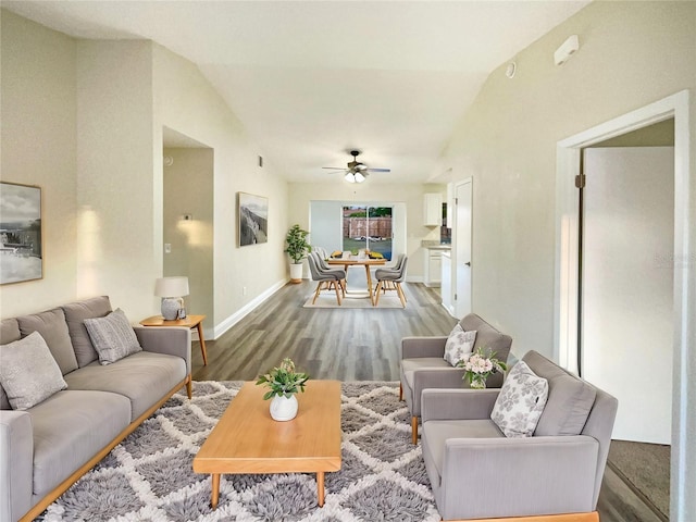 living room with ceiling fan, wood-type flooring, and vaulted ceiling