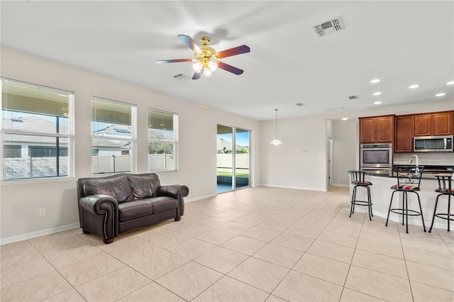 living room featuring ceiling fan and light tile patterned floors