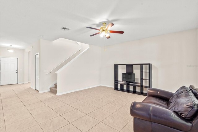 tiled living room with ceiling fan